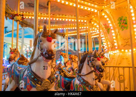 Still Carousel Or Marry-Go-Round With Light Decoration Focus On The Front Horse In Night Atmosphere Stock Photo