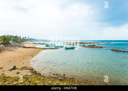 Fishing boats anchored outside a fishermen village in Point Pedro on a stormy day along the northern coast of Jaffna, Sri Lanka Stock Photo