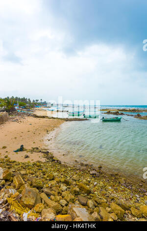 Fishing boats anchored outside a fisherman's village in Point Pedro along the northern coast of Jaffna on a stormy day Sri Lanka Stock Photo