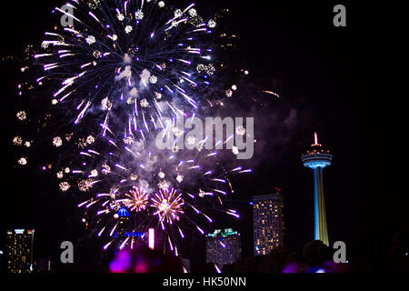 Colorful Fireworks Lighting Up the Sky over Niagra Falls in Canada Stock Photo