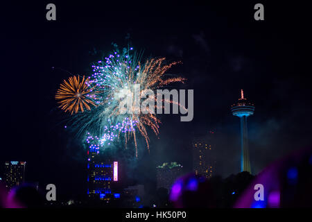 Colorful Fireworks Lighting Up the Sky over Niagra Falls in Canada Stock Photo