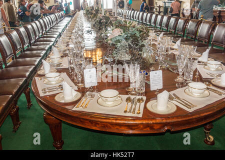 Visitors an Open Day admire the ceremonial dining table as set for a major event at Government House, Melbourne, Victoria, Australia Stock Photo