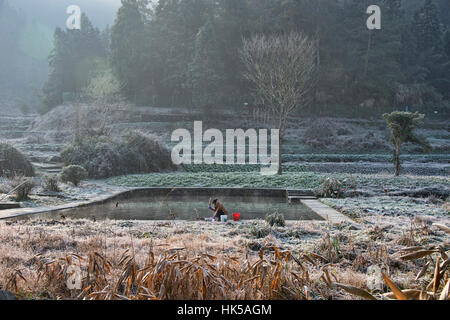 Washing clothes on a cold winter morning in the ancient village of Xidi, Anhui, China Stock Photo