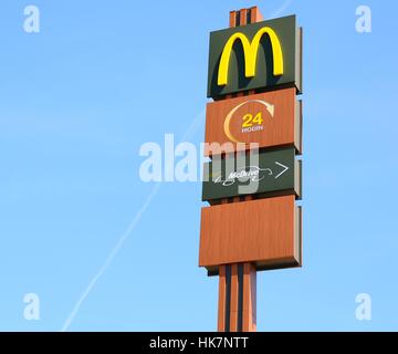 Modern Mc Donalds sign against blue sky. Stock Photo