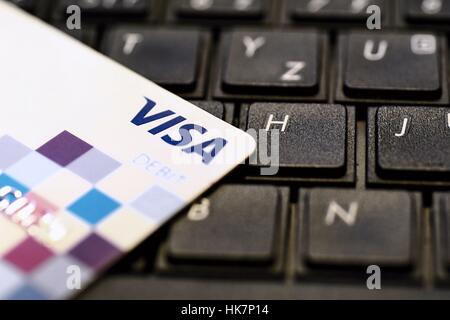 VISA payment debit card put on black keyboard. Stock Photo