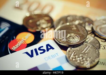 VISA and MasterCard payment debit cards with Czech currency and coins. Stock Photo