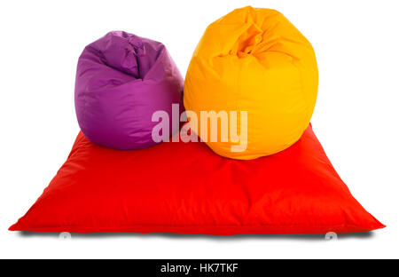 Purple and yellow beanbag chairs on red beanbag sofa isolated on white background Stock Photo