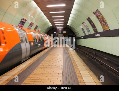 Underground train leaving Cowcaddens Subway Station Glasgow. Stock Photo