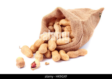 Peanuts in sackcloth bag on white Stock Photo