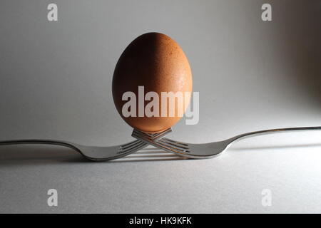 Egg Resting on Forks with Shadow Stock Photo