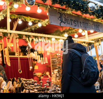 BERLIN, GERMANY - DECEMBER 1 2016: Busy Gendarmenmarkt Christmas Market shoppers browsing handcrafted goods on display. Stock Photo