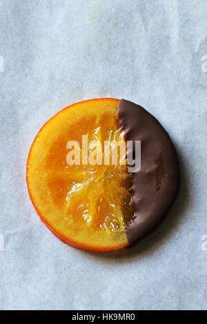 Candied orange slices coated with dark chocolate on white background.Top view Stock Photo