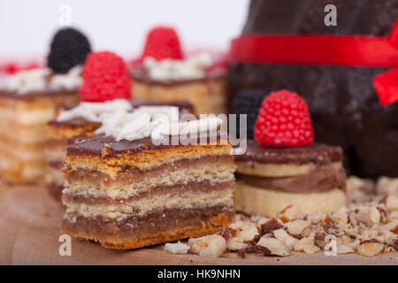 Very tasty chocolate cake on a wooden base, selective focus and small depth of field Stock Photo