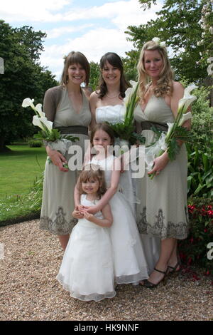 Bride and Bridesmaids posed in a Formal wedding style group Stock Photo