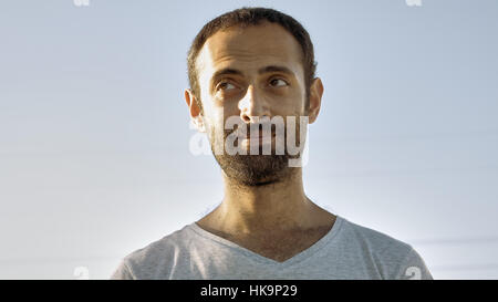 Cheerful man smiles with teeth and nods head Stock Photo