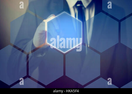 Businessman using pen stylus touching on technology honeycomb interface on virtual screen. Stock Photo