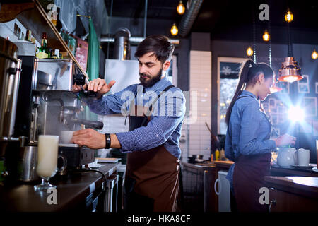 Barman barista uniform making coffee tea cocktails in the bar, r Stock Photo