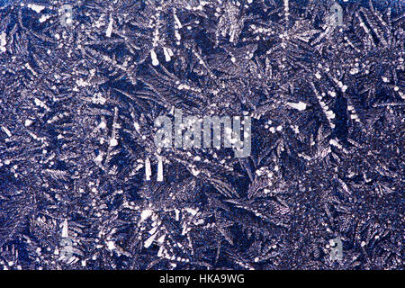 Abstract macro background with ice crystals on a blue metallic surface Stock Photo