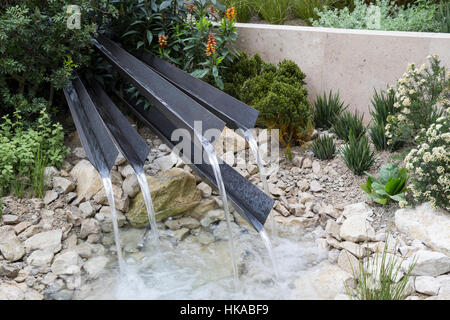 English modern contemporary gravel garden with water feature small pond pool Chelsea Flower Show England UK Designer: Andy Sturgeon Stock Photo