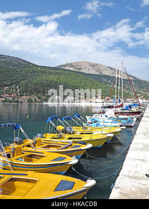 Yellow boats for hire moored along  Sami Harbour, Kefalonia, Greek Ionian Island Stock Photo