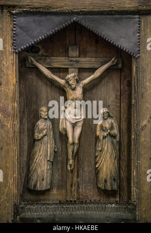 Crucifixion of Christ carved on ancient wooden icon. The wooden figure of the Crucifixion of Christ. Old wooden icon of the Crucifixion of Christ Stock Photo