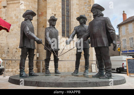 Monument to D'Artagnan and Three Musketeers (2011) by controversial Georgian-Russian sculptor Zurab Tsereteli in front of the Condom Cathedral in Condom, Gers, France. Soviet film stars Veniamin Smekhov as Athos, Igor Starygin as Aramis, Mikhail Boyarsky as d'Artagnan and Valentin Smirnitsky as Porthos are depicted (from left to right) as they appeared in the popular Soviet musical D'Artagnan and Three Musketeers (1978). Stock Photo