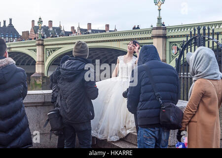 A fashion shoot on a cold, damp January day on London's Albert Embankment Stock Photo