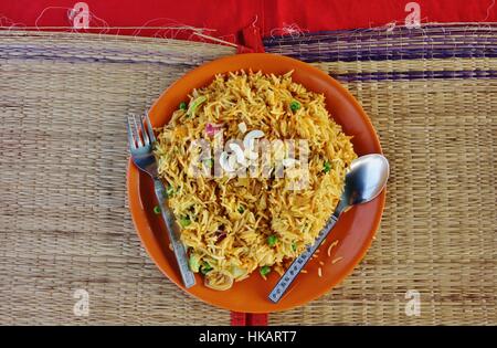 A plate of vegetarian rice biryani with cashews on top Stock Photo