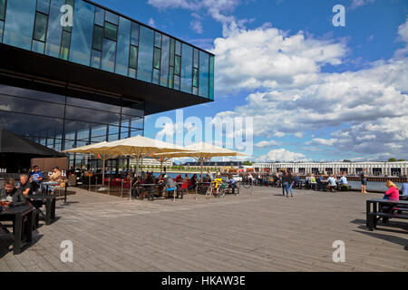 Outdoor cafe at the Royal Playhouse in the inner harbour of Copenhagen. View to Papirøen, the Paper Island, and the nearly hidden Royal Opera House. Stock Photo