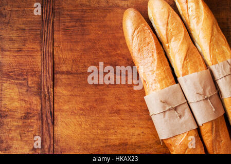 Assortment of baked French baguettes on a wooden table Stock Photo