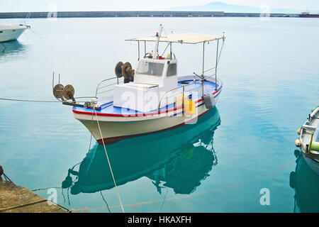 fishing boat reflected on sea at Kalamata port Peloponnese Greece Stock Photo