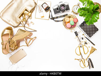 Fashion flat lay for web site social media. Feminine accessories, bag, shoes, office supplies, IPhone and green plant on white table background Stock Photo