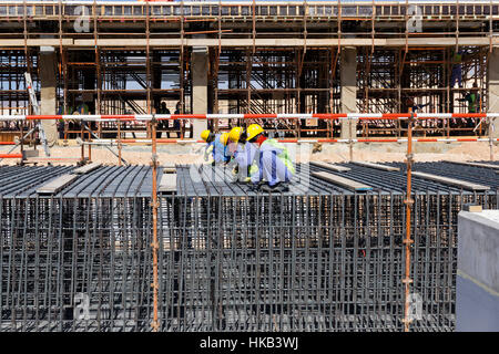 Construction workers knitting rebars for concrete foundation Stock Photo