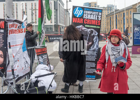 a woman hands out flyers outside investec a major shareholder in hand out flyers in uk
