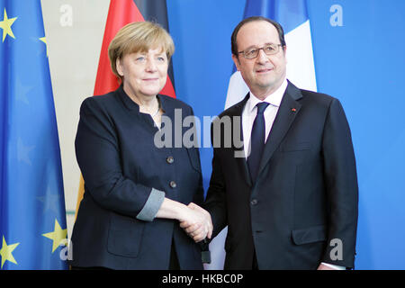 Berlin, Germany. 27th Jan, 2017. German Chancellor Angela Merkel (L) shakes hands with visiting French President Francois Hollande after a joint press conference in Berlin, Germany. Credit: Wang Qing/Xinhua/Alamy Live News Stock Photo