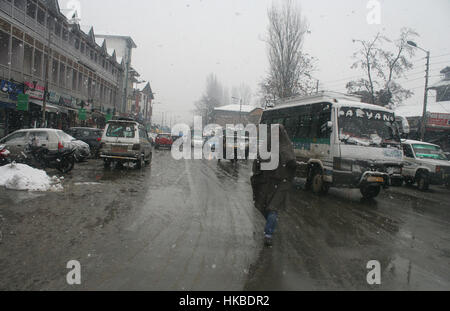 Srinagar, Indian Administered Kashmir. 28th Jan, 2017. A kashmiri man cover him self with a lose cloth known as (pheran) during fresh snow fall.Five soldiers were trapped after a snow track caved in in Kupwara, Jammu and Kashmir, on Saturday. Massive rescue operations were launched soon after the incident, in which two jawans were rescued.Around 20 people have died in avalanches in the state over the past week, including 14 soldiers. Credit: sofi suhail/Alamy Live News Stock Photo