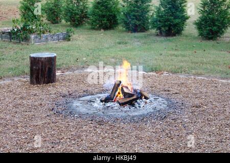 The fire in the fire pit out in the backyard. Stock Photo