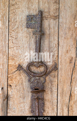 Old key on a wooden antique door (France) Stock Photo