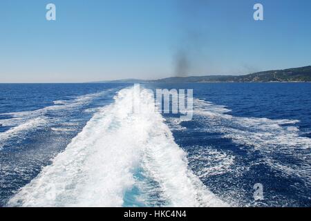 The wake from the stern of a high speed hydrofoil ferry departing from Paxos island in Greece. Stock Photo