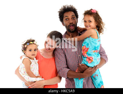 Happy interracial family is celebrating, laughing and having fun with Hispanic African American Father, Caucasian mother and Mulatto children daughter Stock Photo