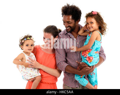 Happy interracial family is celebrating, laughing and having fun with Hispanic African American Father, Caucasian mother and Mulatto children daughter Stock Photo