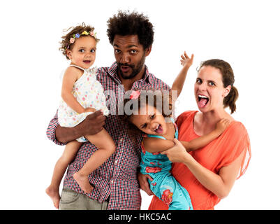 Happy interracial family is celebrating, laughing and having fun with Hispanic African American Father, Caucasian mother and Mulatto children daughter Stock Photo