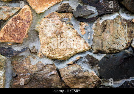 Authentic ancient Medieval stone wall texture. Rock pattern of color stones for modern or classic style design decorative element. Stock Photo