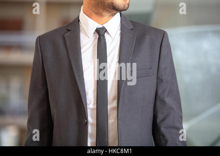 Man in suit on office blurry background Stock Photo