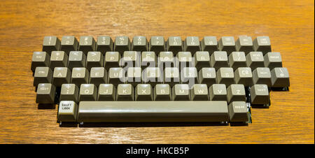 Old keyboard mounted in wooden table Stock Photo
