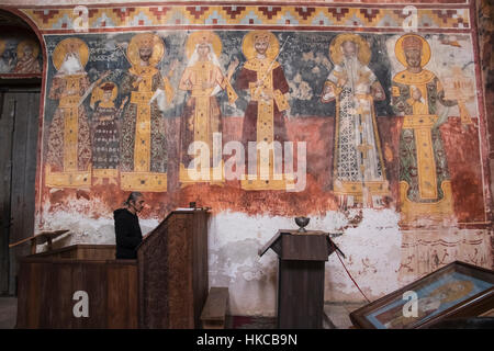 Priest Praying By The Mural Fresco On The North Wall Of The Church Of The Virgin, Depicting Queen Rusudan, Prince Bagrat, King George Ii, Queen Hel... Stock Photo