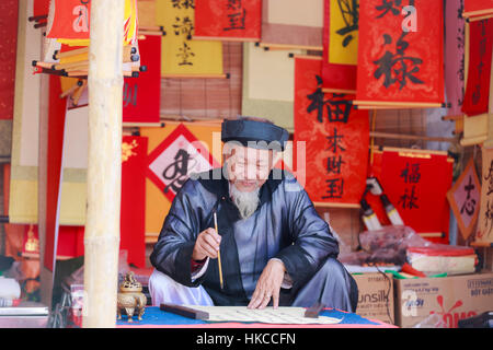 A scholar writes Chinese calligraphy characters at Temple of Literature on January 26,2017 Stock Photo
