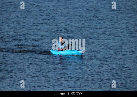 A kayaker in a blue Dagger Zydeco kayak, enjoying the waters of the Firth of Clyde in Scotland. Stock Photo