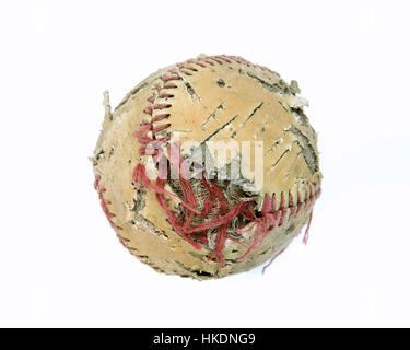 An old baseball that has seen better days. Torn stitches, Discolored leather ripped and torn sitting on a clean white background. Stock Photo