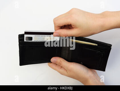 Person taking credit card from black opened wallet Stock Photo